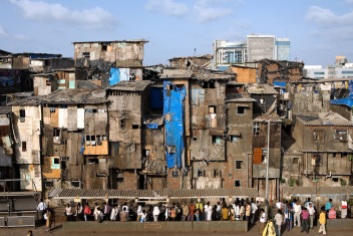 A slum section is photographed from Bandra (East) train station, Mumbai, India. Here, famous child actors Azharuddin Ismail and Rubina Ali, playing the roles of young Salim and young Latika in the movie Slumdog Millionaire, winner of 8 Oscar Academy Awards in December 2008, still live with their families. Various promises were made to lift the two young actors from poverty and slum-life but as of the end of May 2009 anything is yet to happen. Rubinas house was recently demolished with no notice as it lay on land owned by the Maharashtra train authorities and she is now permanently living with her uncles family in a home a stone-throw away in the same slum. Azharuddins home too was demolished in the past two weeks, as it happens every year in his case, because the concrete walls were preventing local authorities to clear a drain passing right behind it. As usual, his father is looking into restoring the walls as soon as the work on the drain has been completed.